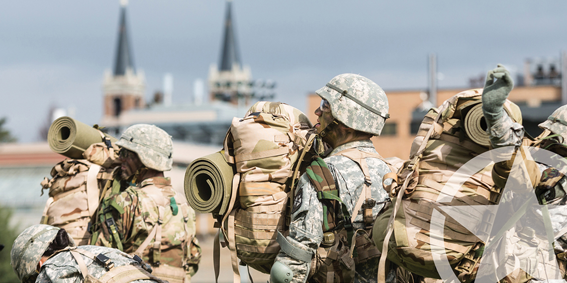 military students prepare to load helicopter on campus