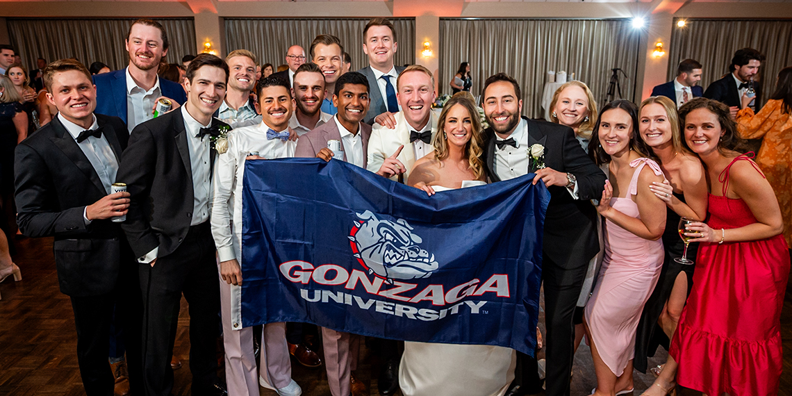 16 Matthew Winterle married Julia Murphy holding the Gonzaga flag with their wedding party.
