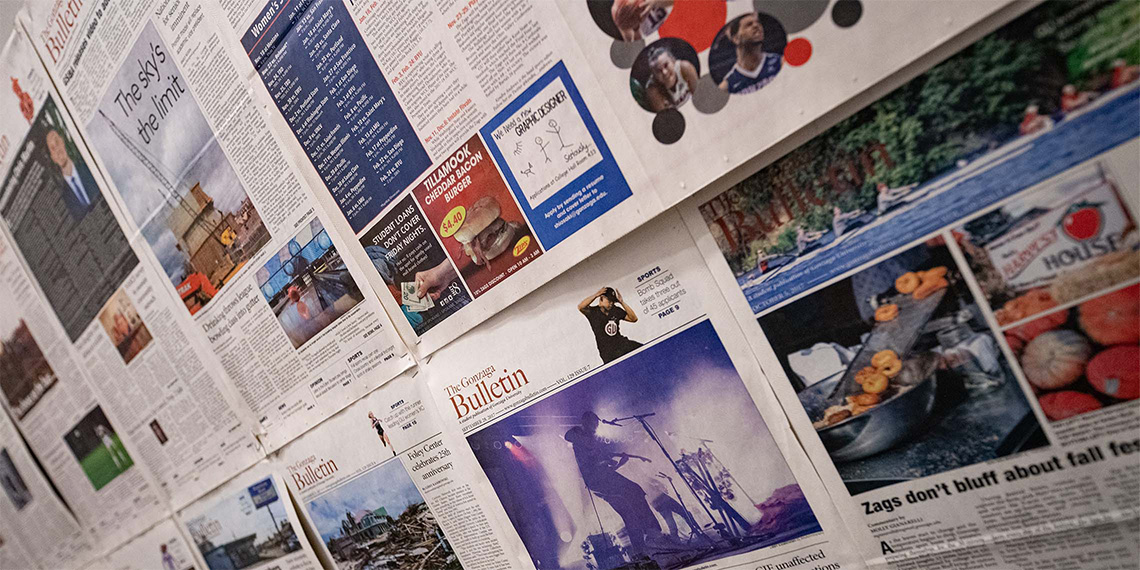 A wall of newspapers in the GU Student Media office.