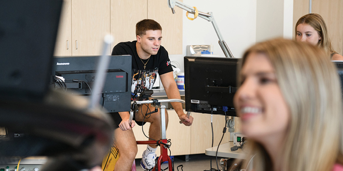 Human Physiology students using the exercise lab equipment.