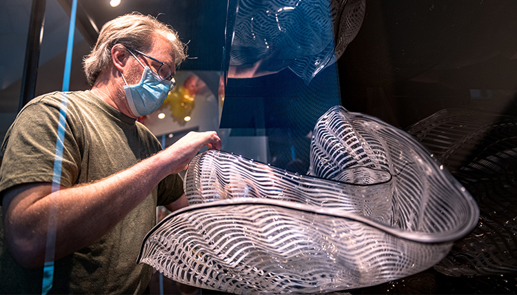 paul handles a piece of chihuly glass art