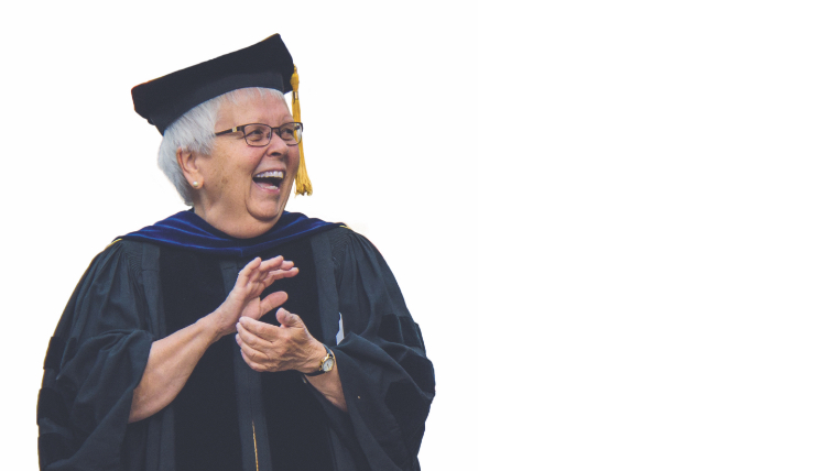 sister joy milos in cap and gown laughing