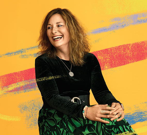 A professor and student look at a computer screen in a laboratory