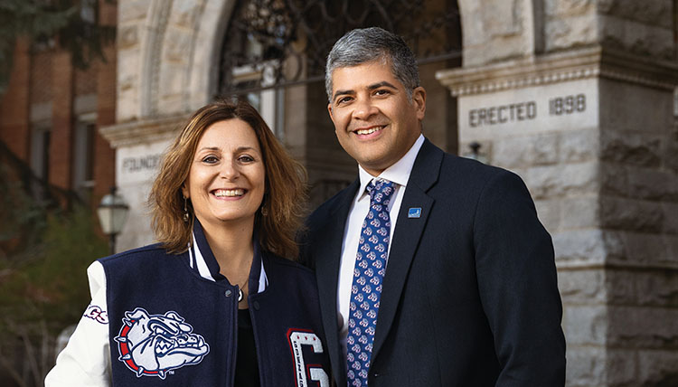 President Passerini and husband Arturo Pagán smiling in front of College Hall