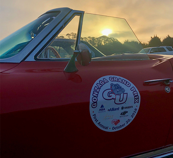 A vintage car with a Gonzaga Bay Area alumni decal on the side.  