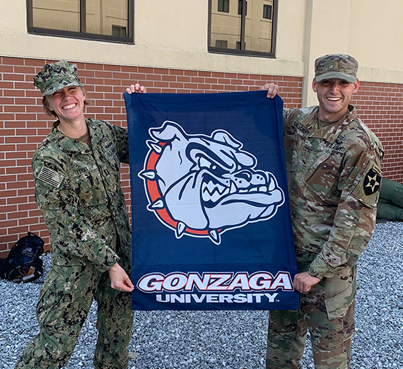 Two Airborne grads hold a Gonzaga flag 