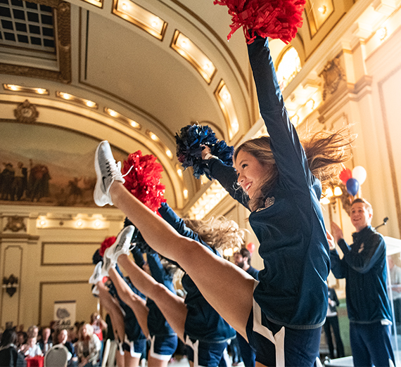 A group of cheerleaders perform a routine. 