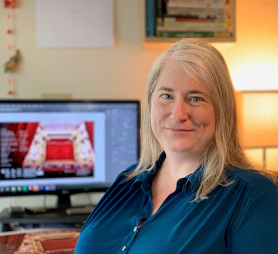 female editor sitting at computer desk