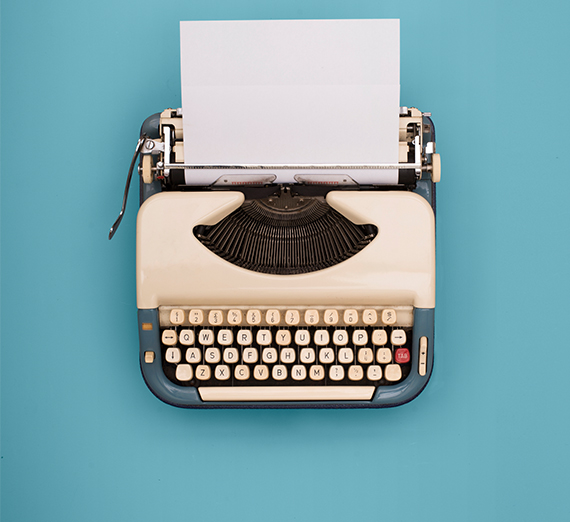 old fashioned typewriter against blue background