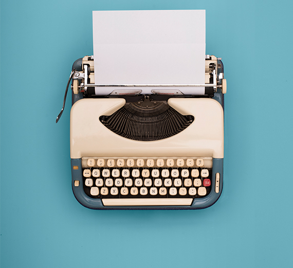 old fashioned typewriter against blue background 