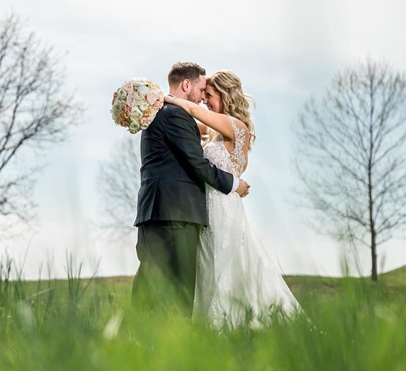 bride and groom embrace outdoors 