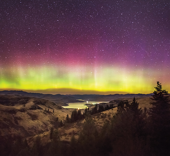 The Aurora Borealis, which symbolizes the spiritual themes of discernment, hovers over the Columbia River and Keller Ferry in Eastern Washington. 