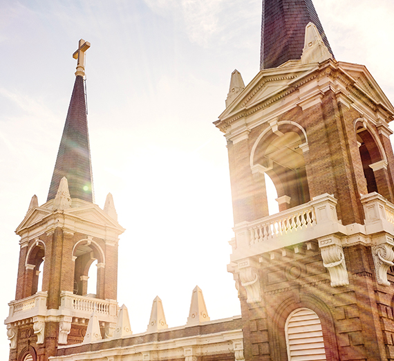 The sun shining through the spires of Gonzaga's St. Aloysius Catholic Church