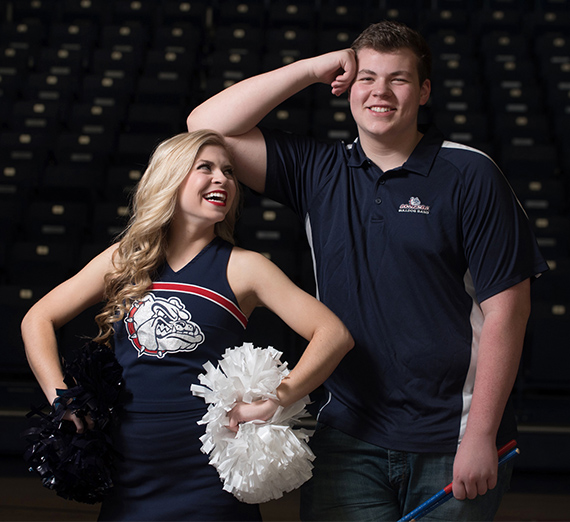 brother and sister in cheer and band uniforms