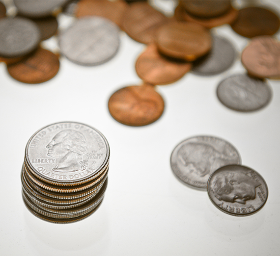 Loose coins are featured on a white background.  