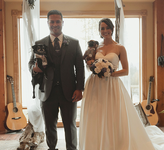 wedding man and woman holding their dogs