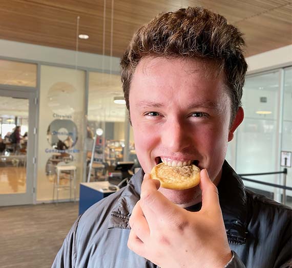 Student eating a COG cookie