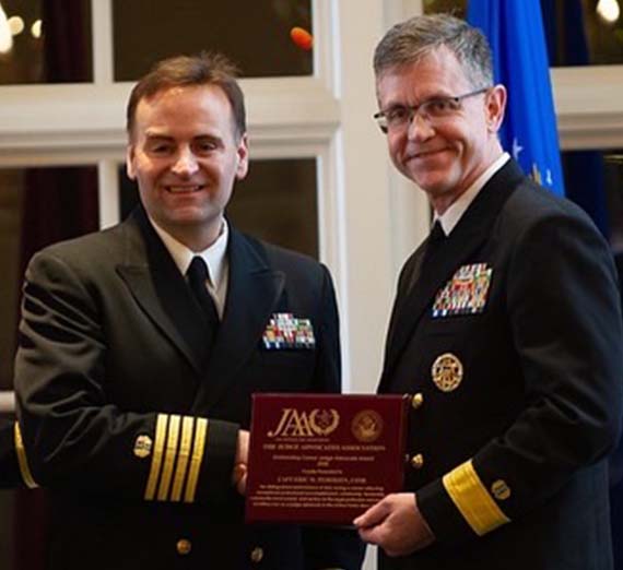 Man in uniform on left and woman posing for headshot on the right.
