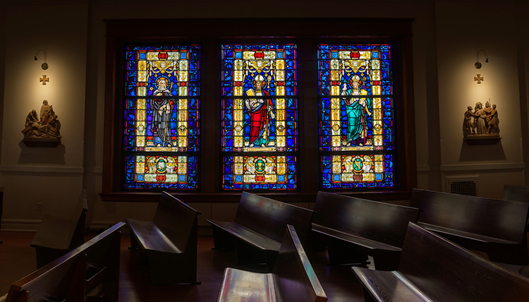 stained glass windows reflecting on pews