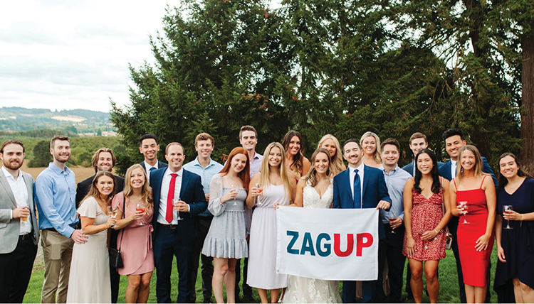 wedding couple and group of friends with zag up flag
