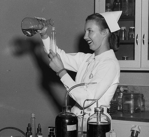 Gonzaga nurse in the 1960's, pouring a build into a vial.