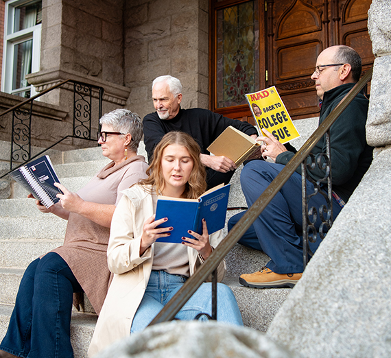 four people on college hall steps