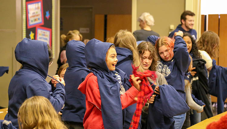 Children from Bemiss and Stevens Elementary Schools receiving their hoodies from Gonzaga.