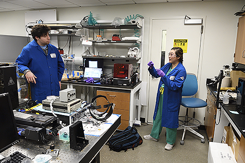 Helen Xun in the lab with Christopher Shallal, a member of the team and a junior majoring in biomedical engineering. (Photo: Will Kirk / Johns Hopkins University)