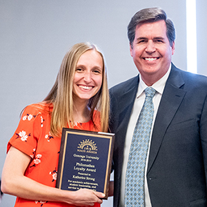 female student standing with president thayne mcculloh