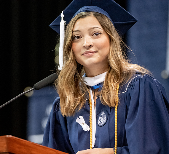 young woman grad at podium 
