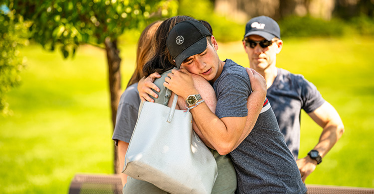 A mother and son embrace and say goodbye during Welcome Weekend