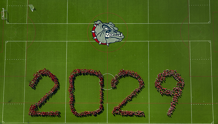 student spelling out 2029 on a green field