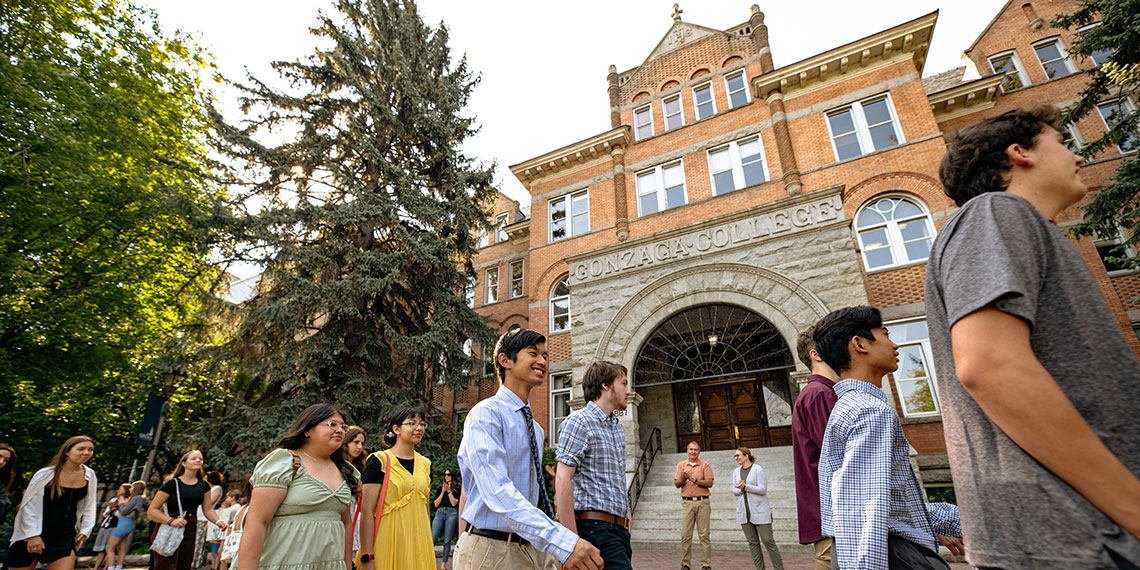 Students walk in front of College Hall before Academic Convocation