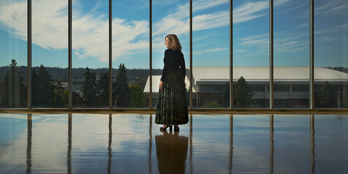 President Katia Passerni stands in front of windows in Hemmingson Center