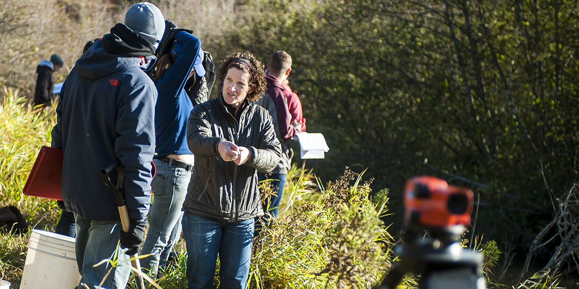 Sue Niezgoda, associate professor of civil engineering, leads a stream restoration class along the Little Spokane River. (GU photo) 