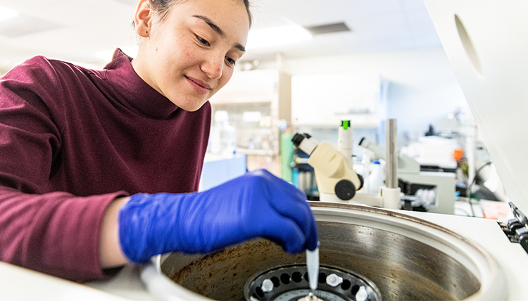 female student using lab equipment