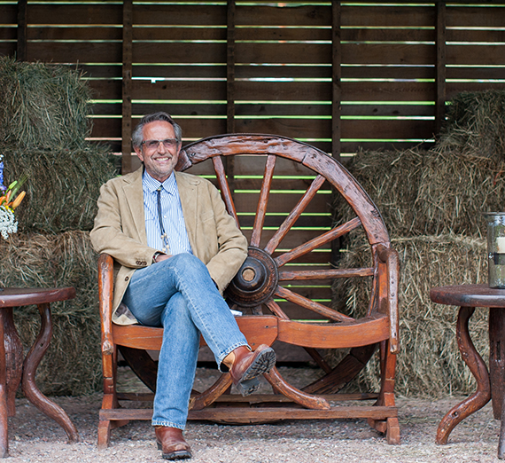 Bob Chapman, CEO of Barry-Wehmiller, sitting on a chair. 