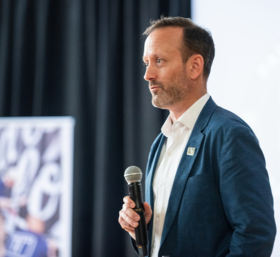 Dan Futrell standing and talking into a microphone