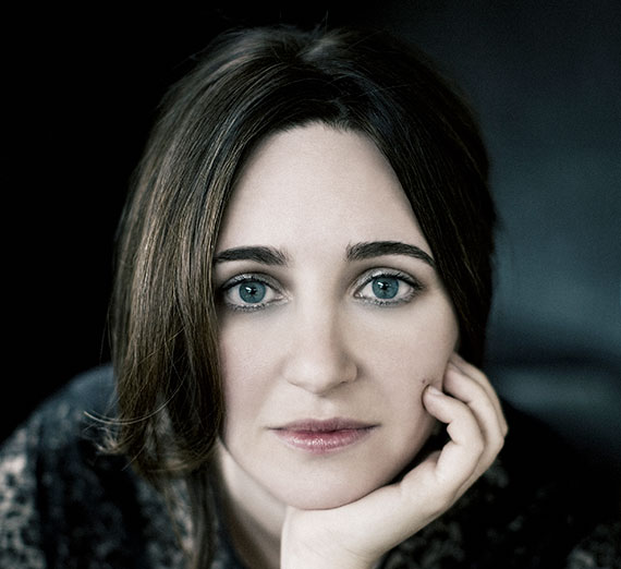 Simone Dinnerstein stares at camera, her head in her hand 