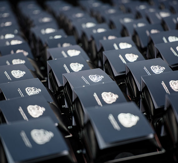 Commencement programs sitting on top of folding chairs