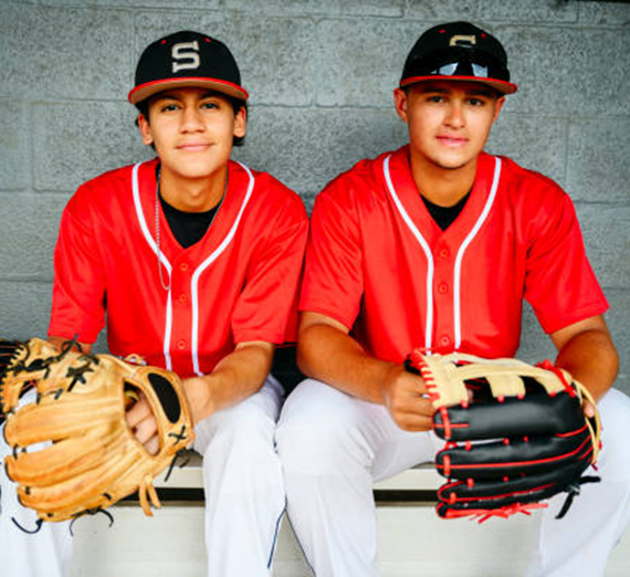 Two young baseball players from Ecuador looking at the camera