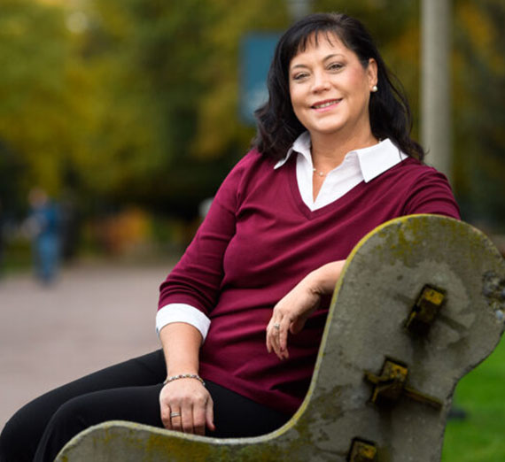 Lisa Schwartzenburg sitting on a GU campus bench