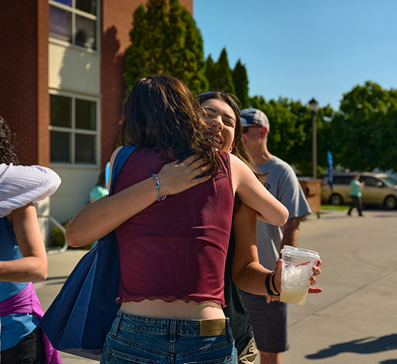 students hugging