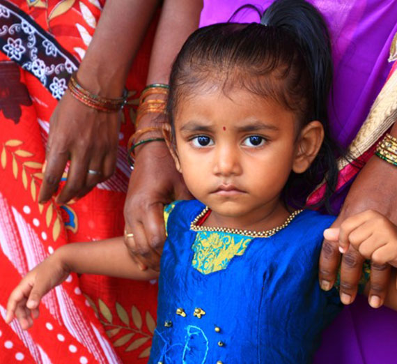 A little girl in India stares into the camera