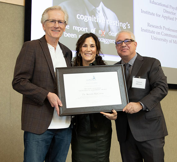 Kevin McGrew (left) receives the Alan S. Kaufman Award from Yolanda Gallardo, Dean of the School of Education (center), and Vincent Alfonso (right), Chair of the Dept. of School Psychology. 