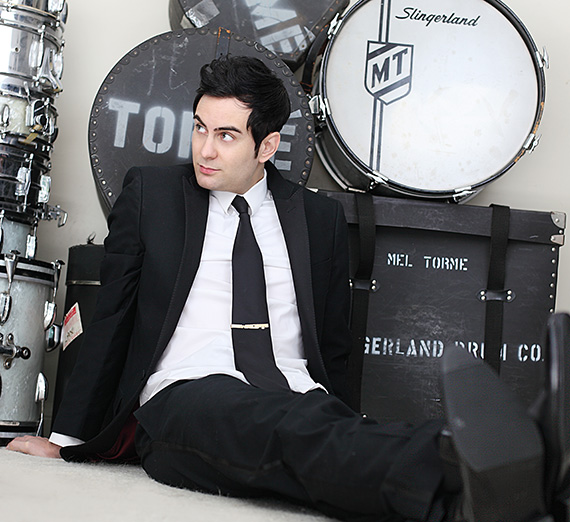 James Torme sits in front of a drum kit