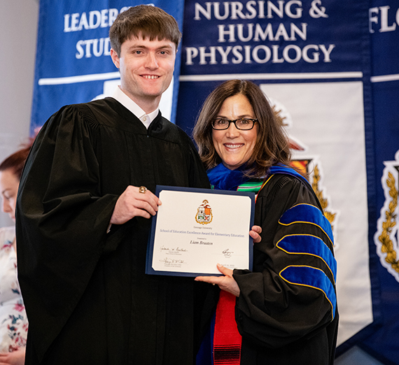 Senior Liam Braaten poses with School of Education Dean Yoli Gallardo