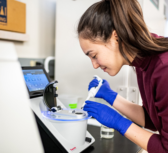 a female student using lab equipment