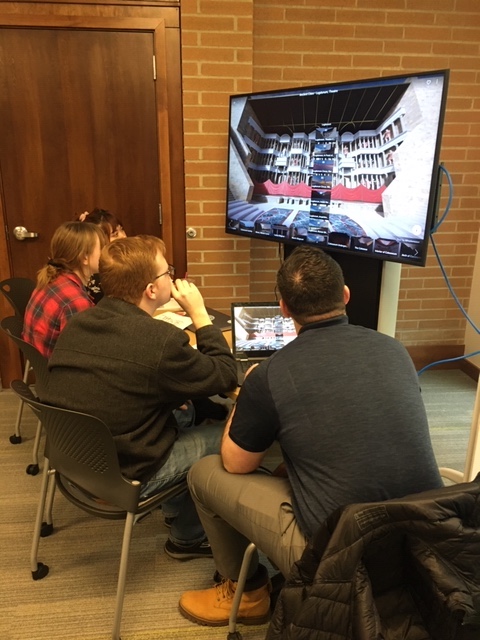 Students viewing an ancient site with VR technology.