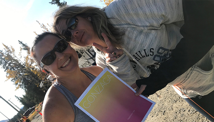 two women holding a copy of Gonzaga Magazine